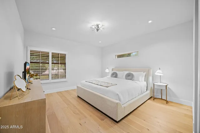 a living room with a bed furniture and a large window
