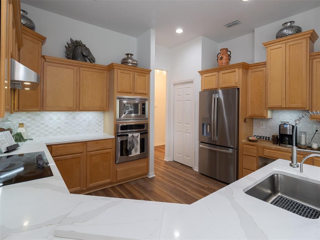 14335 North US Highway 441 Citra, FL 32113 - Photo 11 of 40 a kitchen with granite countertop a refrigerator and a sink