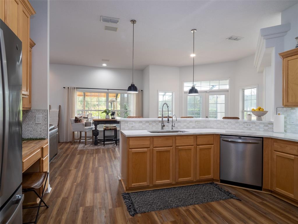 14335 North US Highway 441 Citra, FL 32113 - Photo 13 of 40 a large kitchen with lots of counter space dining table and stainless steel appliances