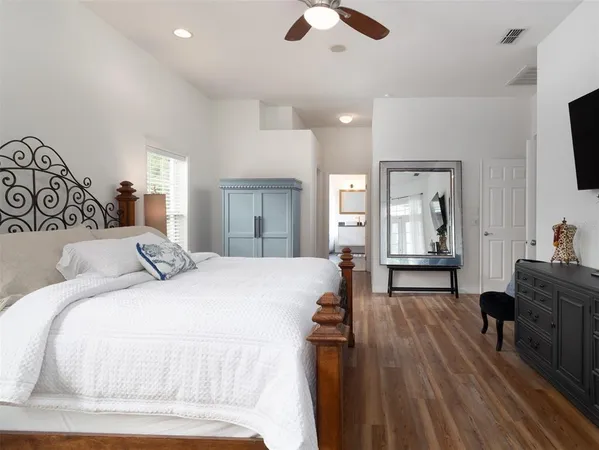 a bedroom with a bed and a lamp