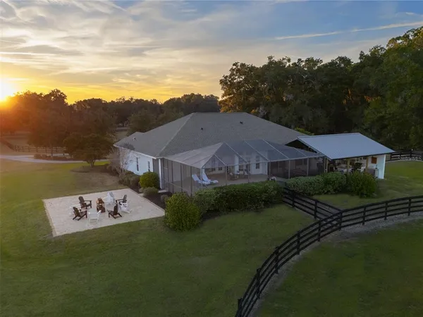a roof deck with table and chairs and potted plants