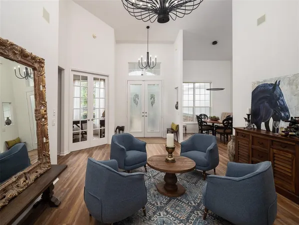 a living room with furniture a rug and a chandelier
