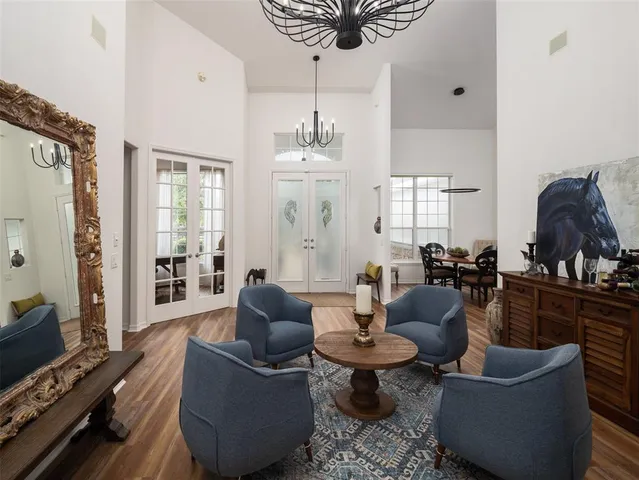 a living room with furniture a rug and a chandelier