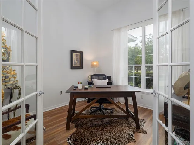 a view of a workspace with furniture and a window