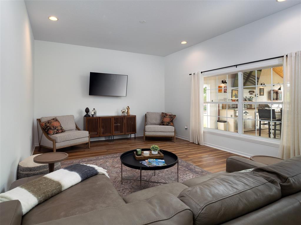 14335 North US Highway 441 Citra, FL 32113 - Photo 9 of 40 a living room with furniture and a flat screen tv