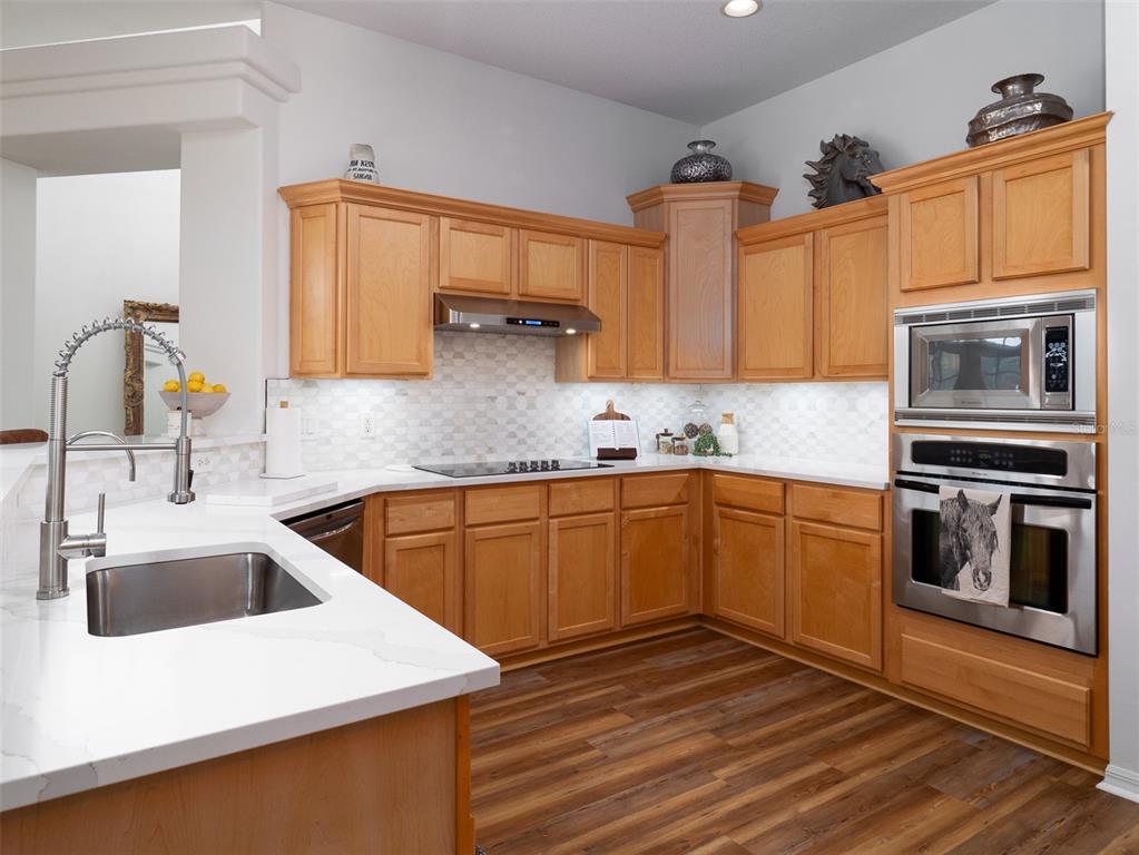 14335 North US Highway 441 Citra, FL 32113 - Photo 10 of 40 a kitchen with stainless steel appliances granite countertop a sink and stove top oven