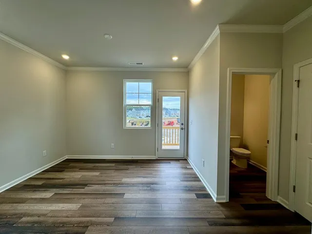 a view of room with window and hardwood floor