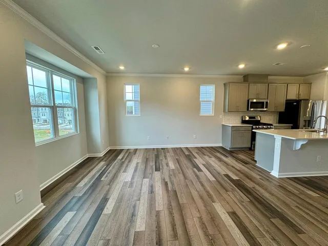 a view of kitchen with wooden floor and electronic appliances