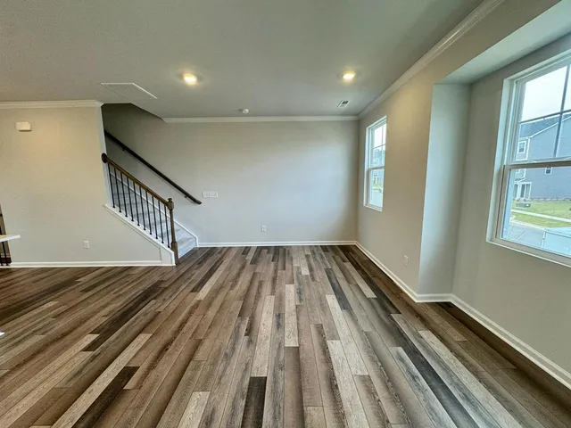a view of a room with wooden floor