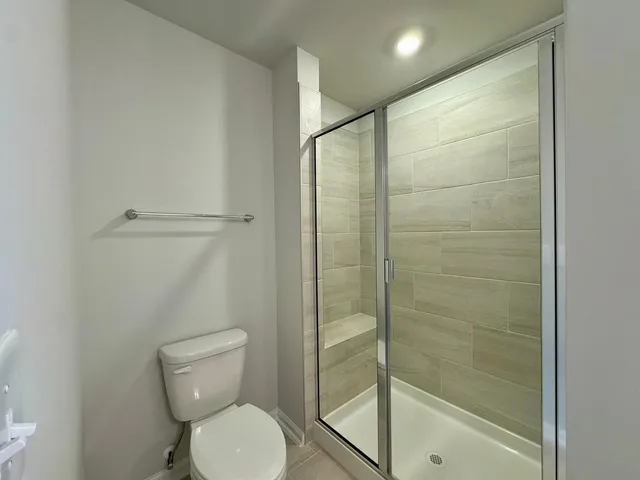 a bathroom with a toilet and a shower