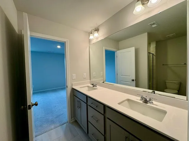 a bathroom with a double vanity sink and a mirror