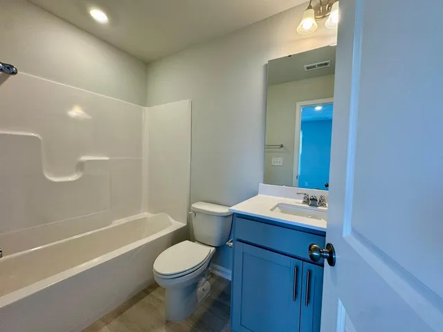 a bathroom with a toilet a sink and bathtub