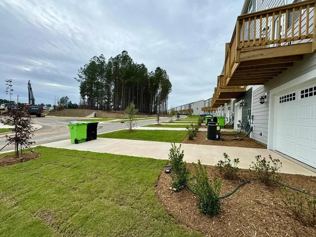 a view of a backyard with swimming pool