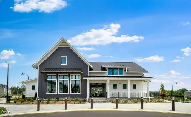a front view of a residential apartment building with a yard