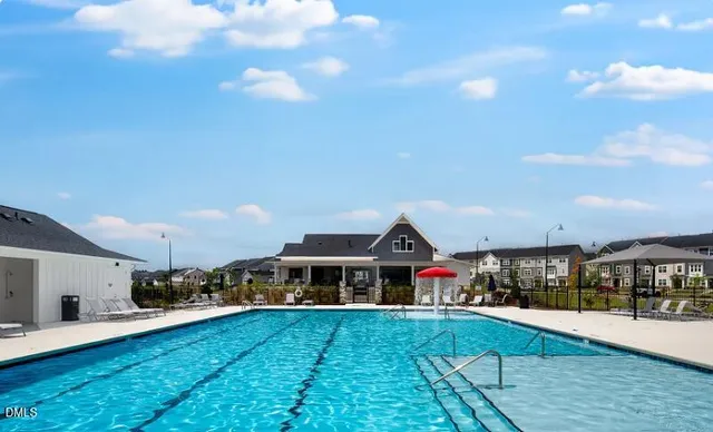 a aerial view of a house with swimming pool having outdoor seating