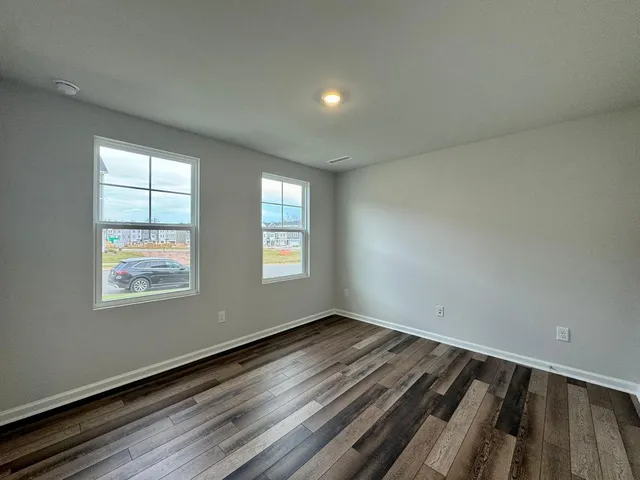 a view of room with window and wooden floor