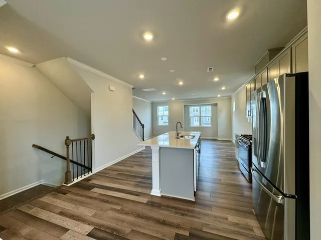 a view of kitchen with furniture and refrigerator