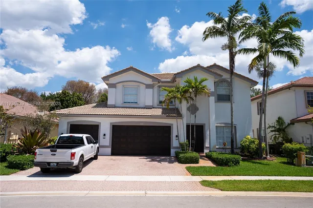 a car parked in front of white house