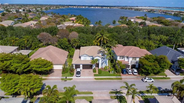 an aerial view of a house with garden space and a street view
