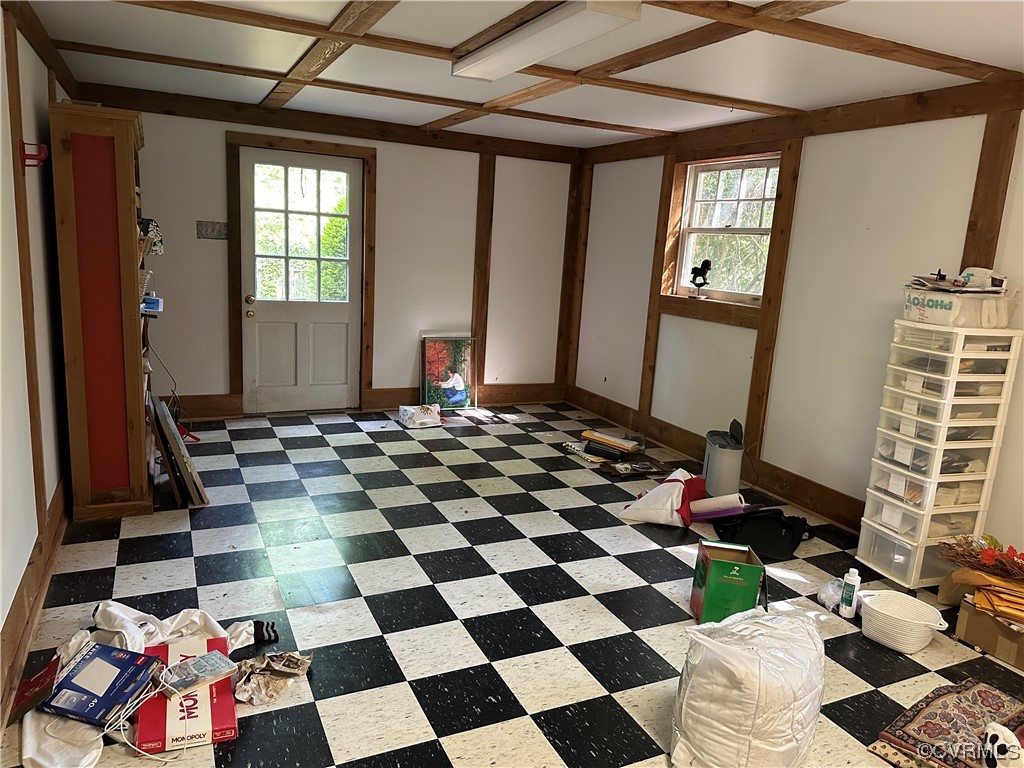 10254 Mannheim Drive Ashland, VA 23005 - Photo 33 of 43 a room with a black white checkered floor with a gaming machine and dining chairs
