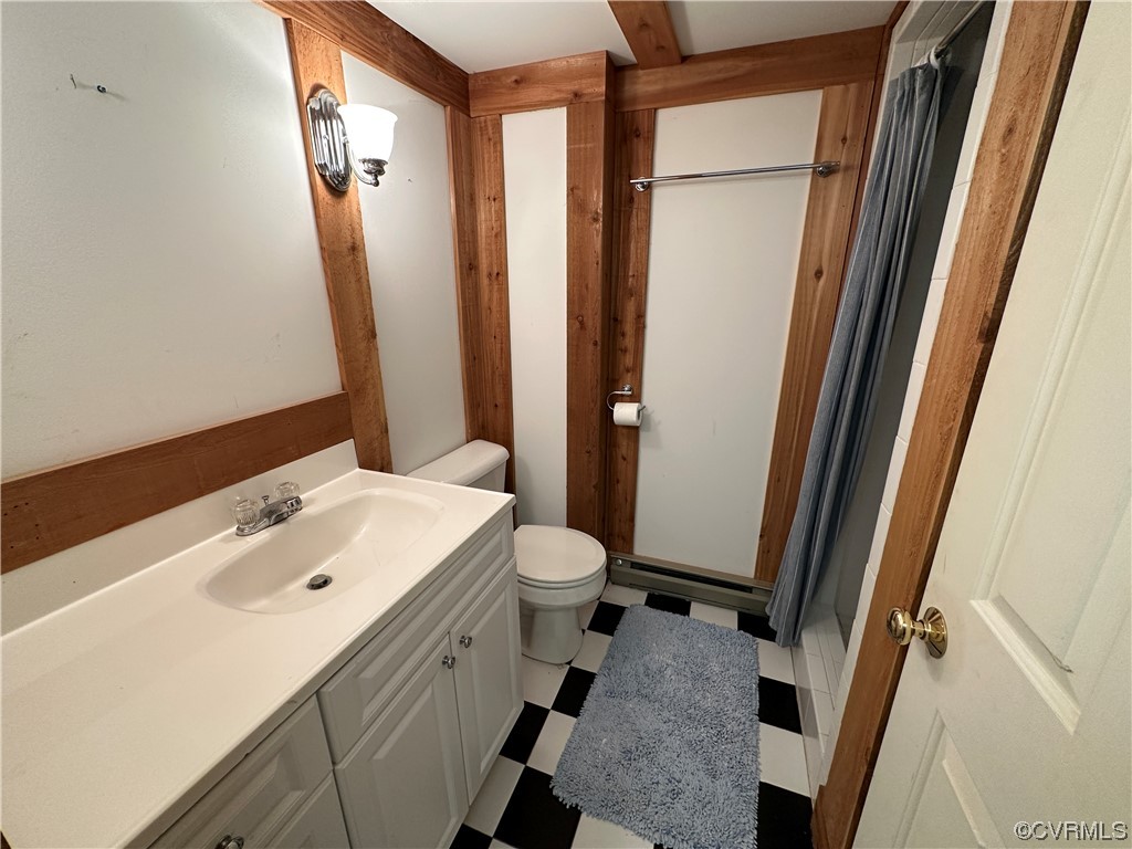 10254 Mannheim Drive Ashland, VA 23005 - Photo 35 of 43 a bathroom with a sink a toilet a mirror and shower