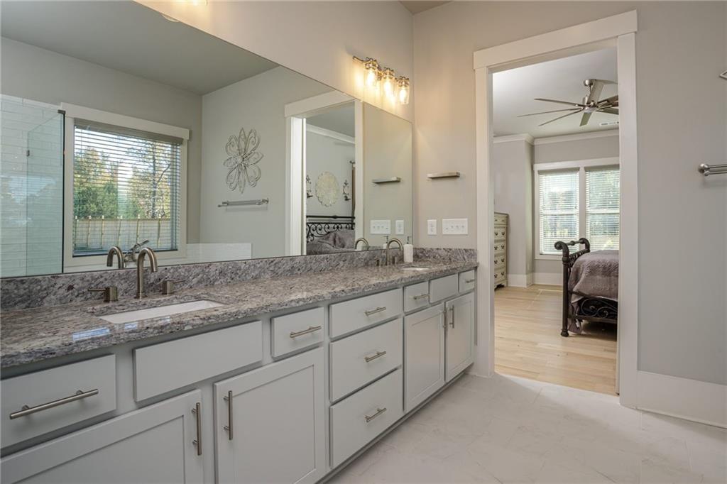 255 Old Town Road Dacula, GA 30019 - Photo 30 of 38 a spacious bathroom with a granite countertop sink and a mirror