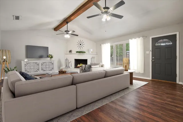 a living room with furniture and a fireplace