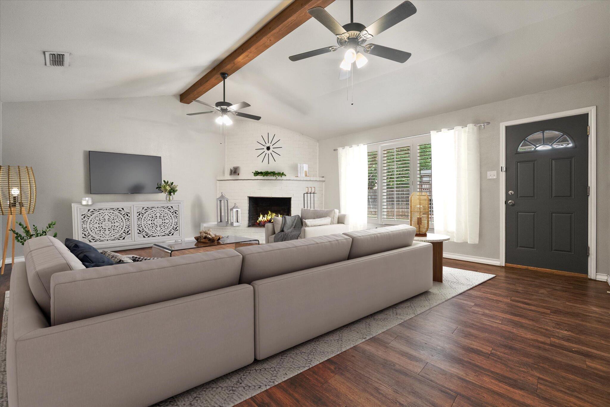 5309 77th Street Lubbock, TX 79424 - Photo 13 of 37 a living room with furniture and a fireplace