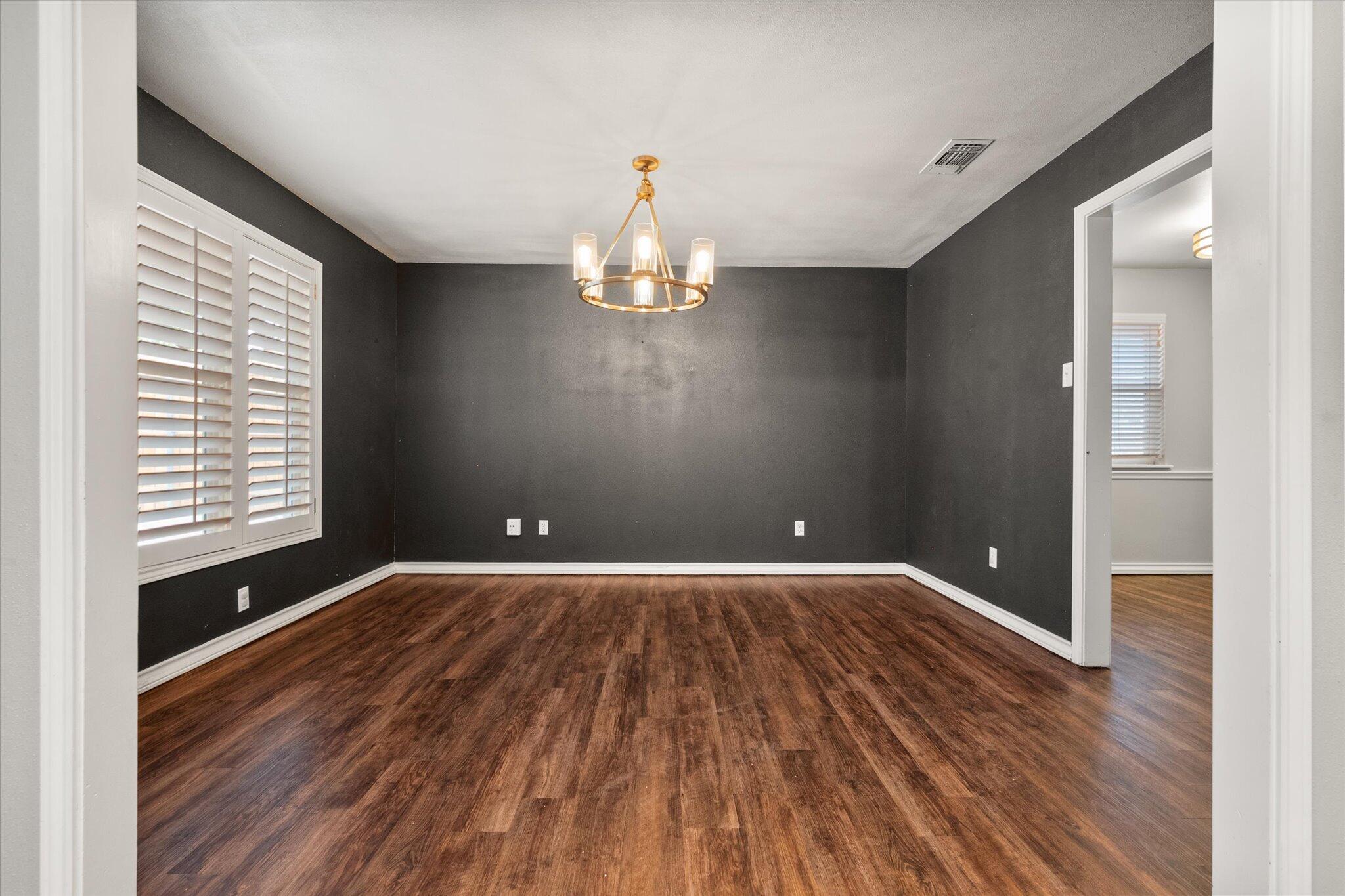 5309 77th Street Lubbock, TX 79424 - Photo 19 of 37 wooden floor in an empty room with a window