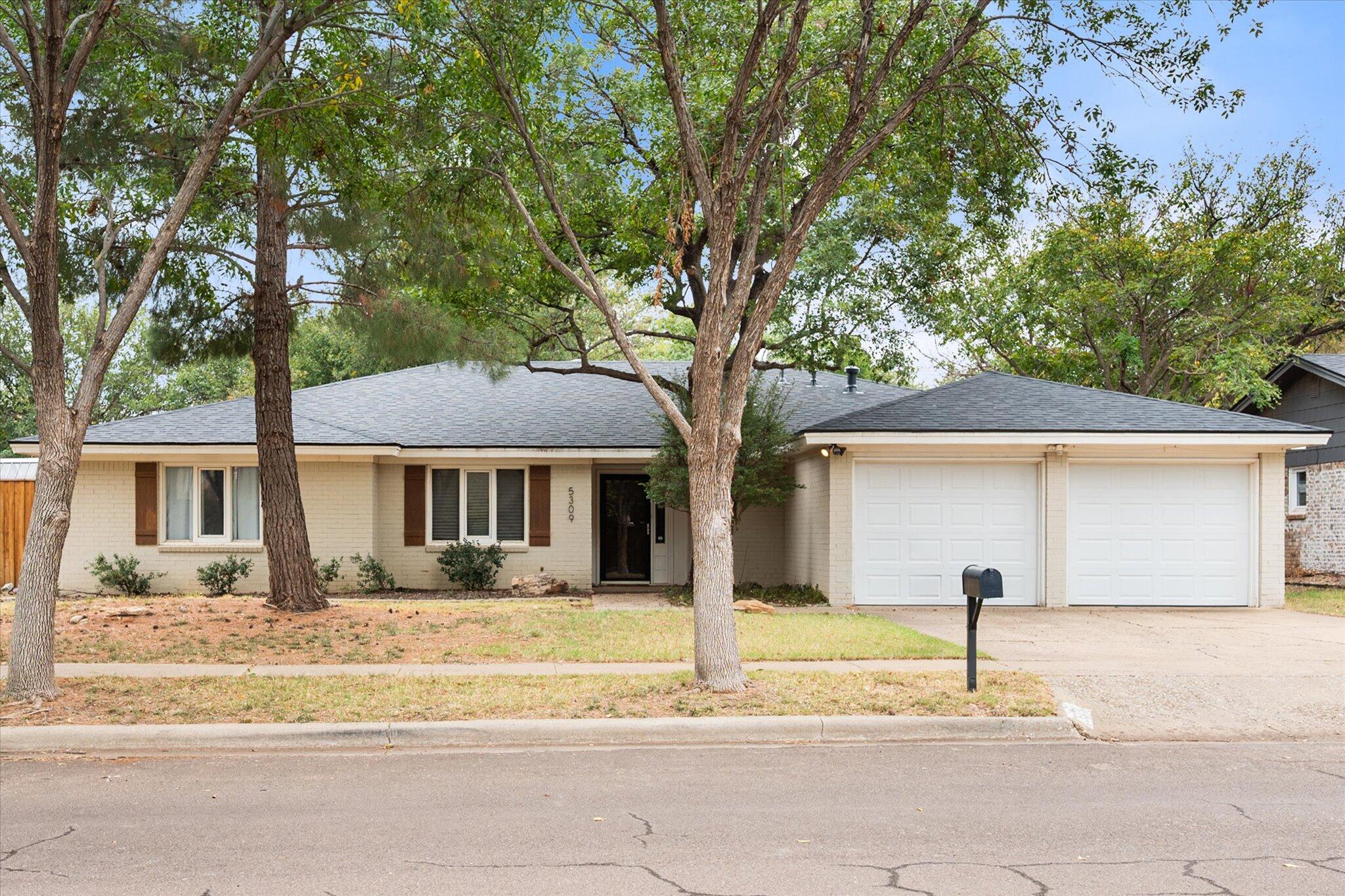5309 77th Street Lubbock, TX 79424 - Photo 2 of 37 a front view of a house with a tree