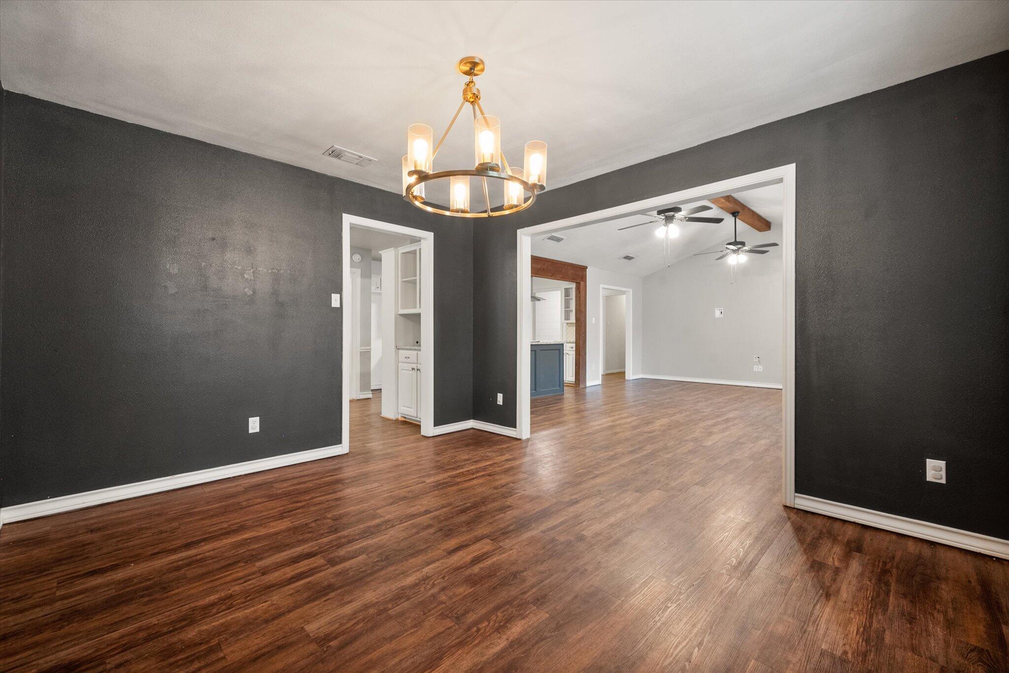5309 77th Street Lubbock, TX 79424 - Photo 21 of 37 a view of a livingroom with a chandelier fan and wooden floor