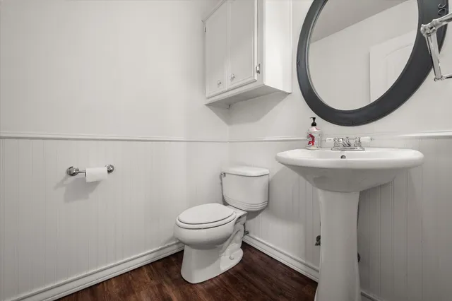 a bathroom with a sink toilet and a mirror