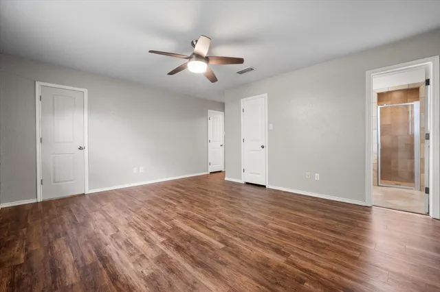 a view of an empty room with wooden floor