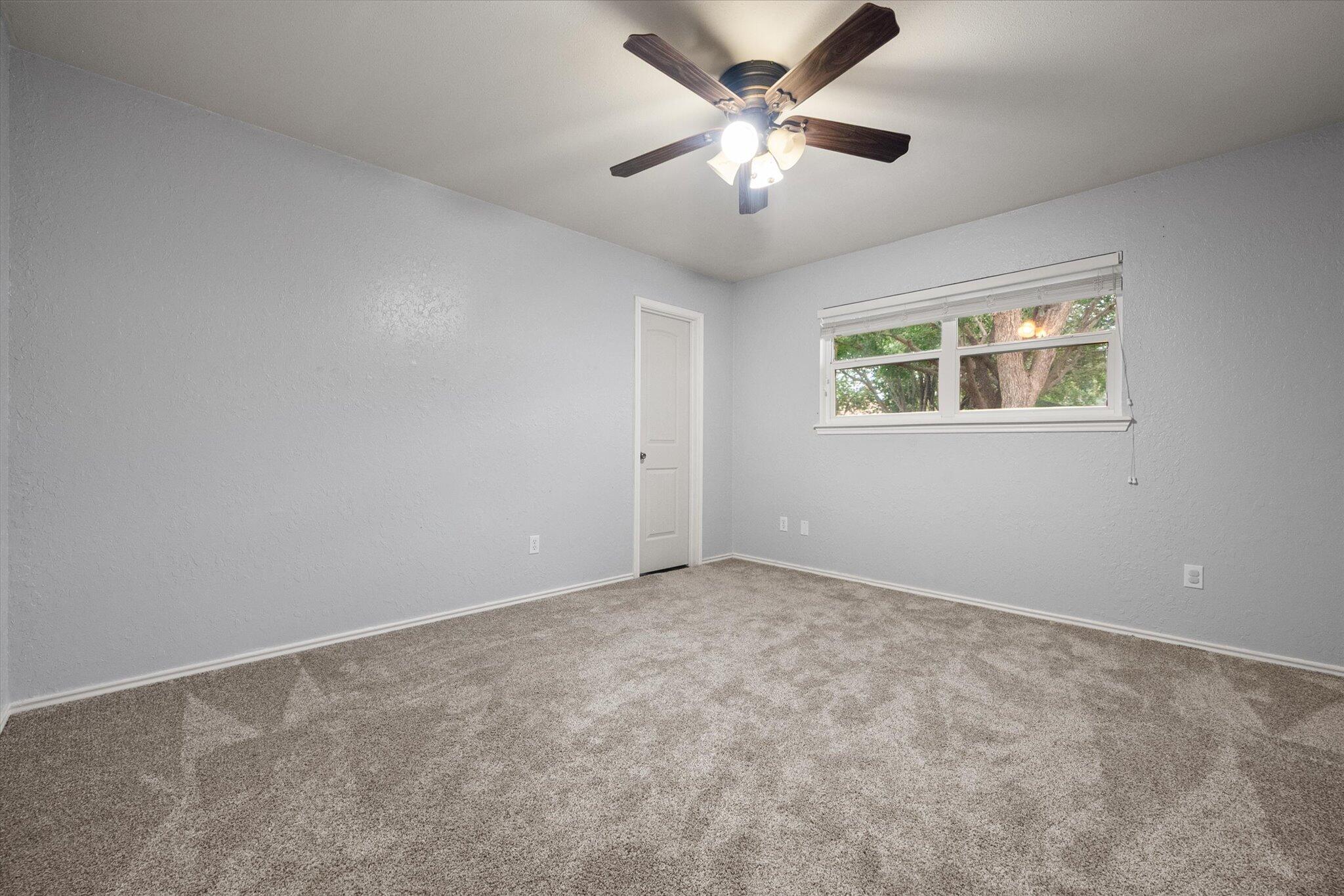 5309 77th Street Lubbock, TX 79424 - Photo 28 of 37 an empty room with chandelier fan
