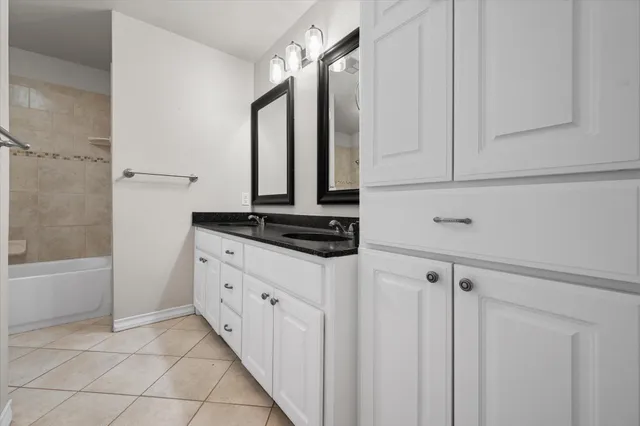 a kitchen with white cabinets and a sink