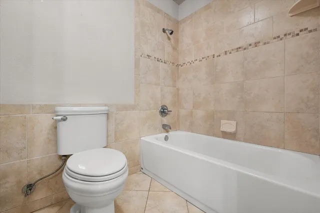 a bathroom with a toilet and shower