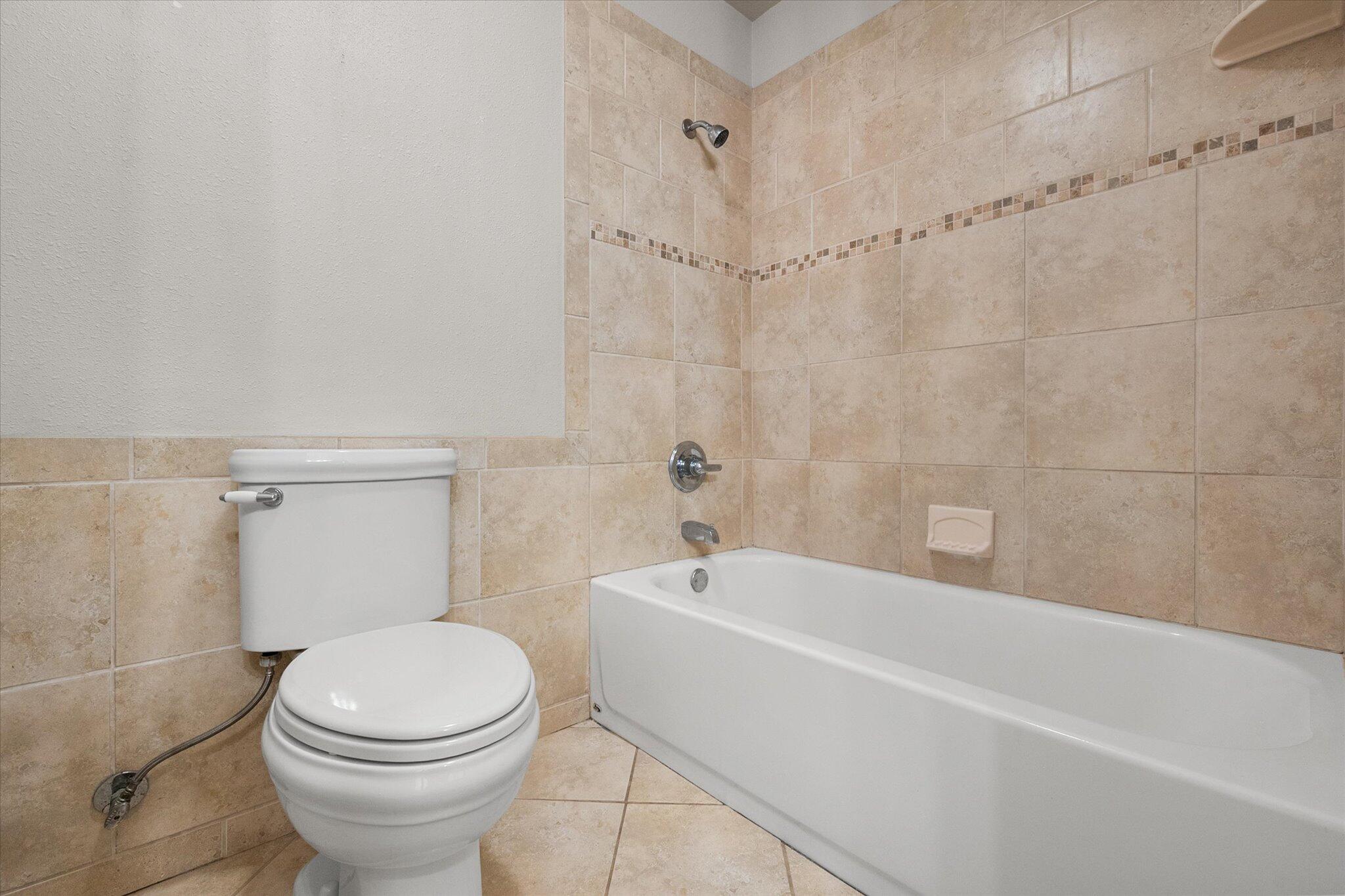 5309 77th Street Lubbock, TX 79424 - Photo 30 of 37 a bathroom with a toilet and shower