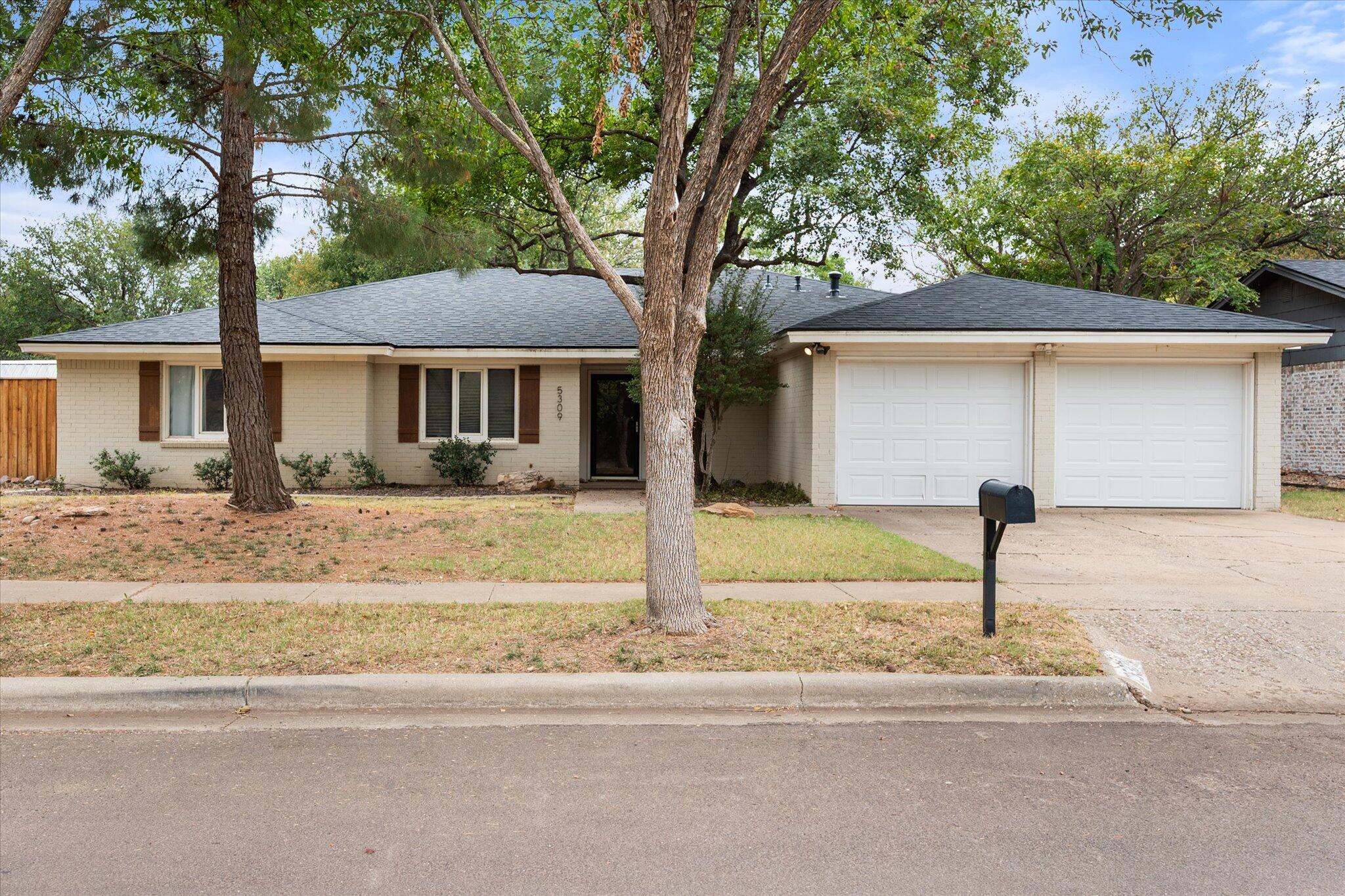 5309 77th Street Lubbock, TX 79424 - Photo 3 of 37 a front view of a house with garden