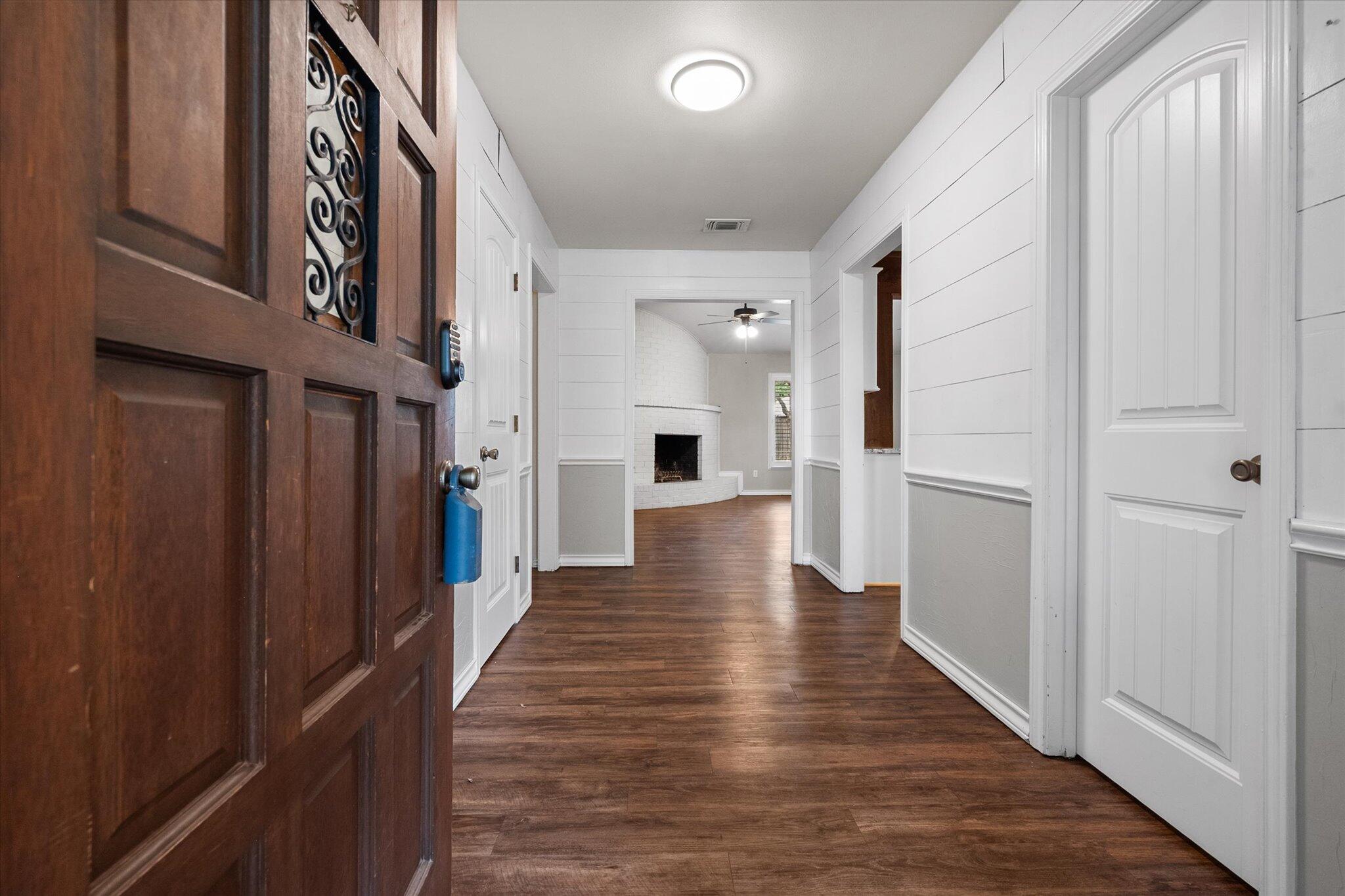 5309 77th Street Lubbock, TX 79424 - Photo 6 of 37 a view of a hallway with wooden floor and staircase