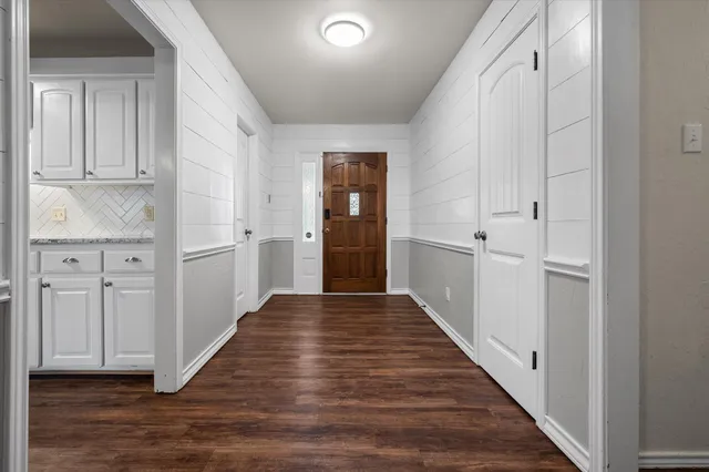 a view of a hallway with wooden floor