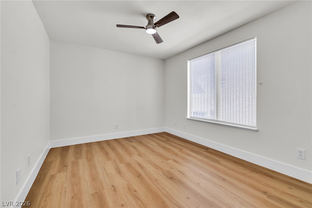 370 Rushing Creek Court Henderson, NV 89014 - Photo 24 of 32 Warm wood flooring and a large window create a serene atmosphere in this versatile space.