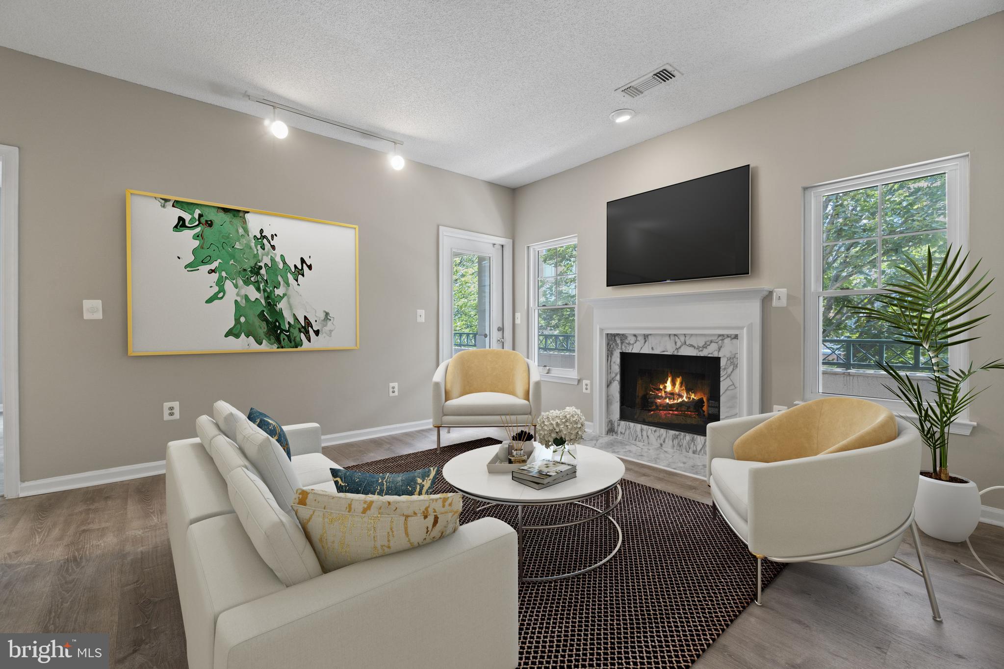 12005 Taliesin Place, Unit 23 Reston, VA 20190 - Photo 11 of 32 Family room with fireplace (Virtually staged)