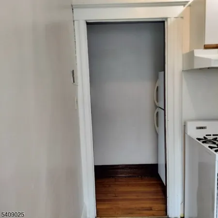 a view of hallway with wooden floor