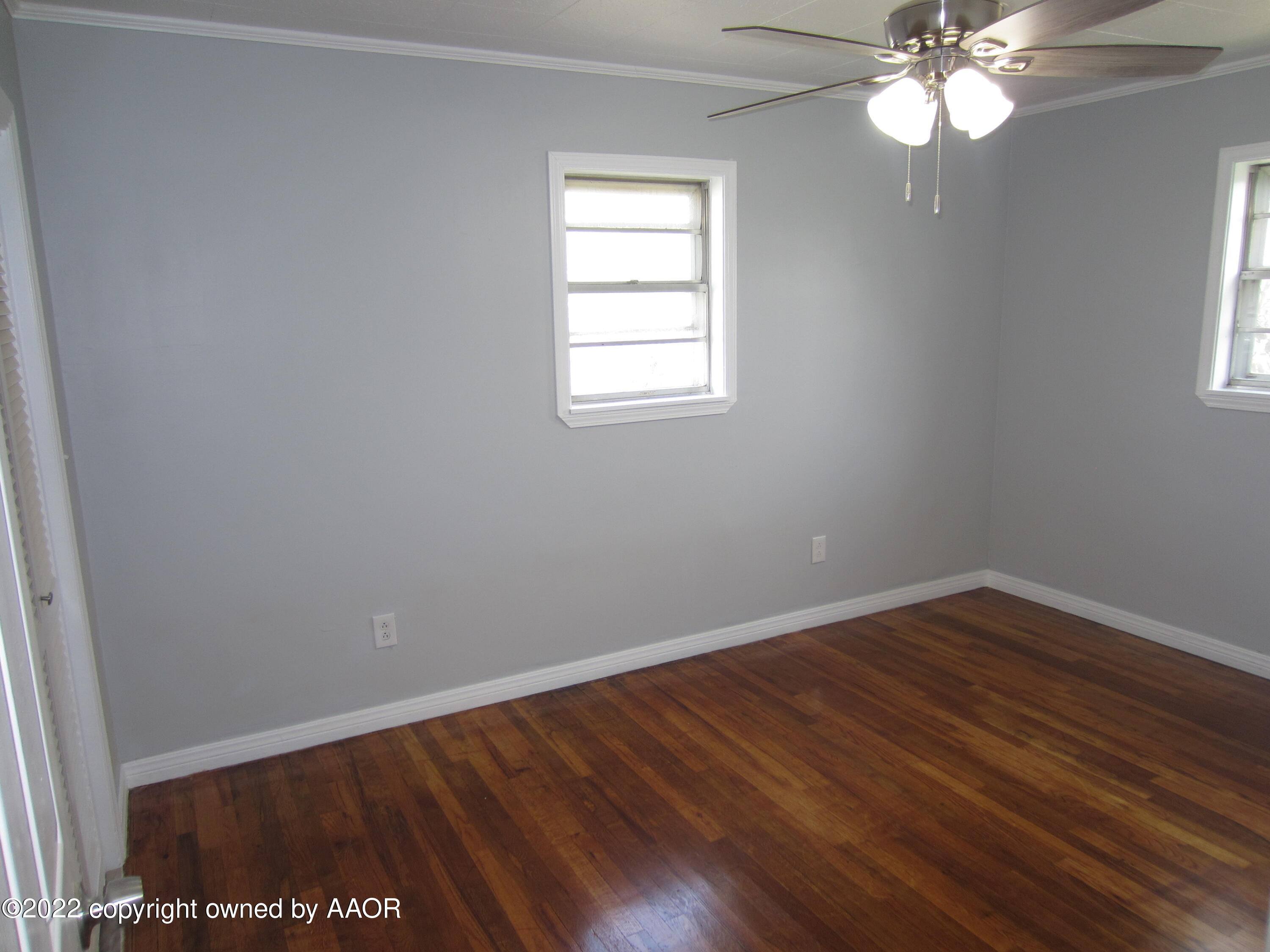 2002 North Mirror Street Amarillo, TX 79107 - Photo 11 of 13 wooden floor in an empty room with a window