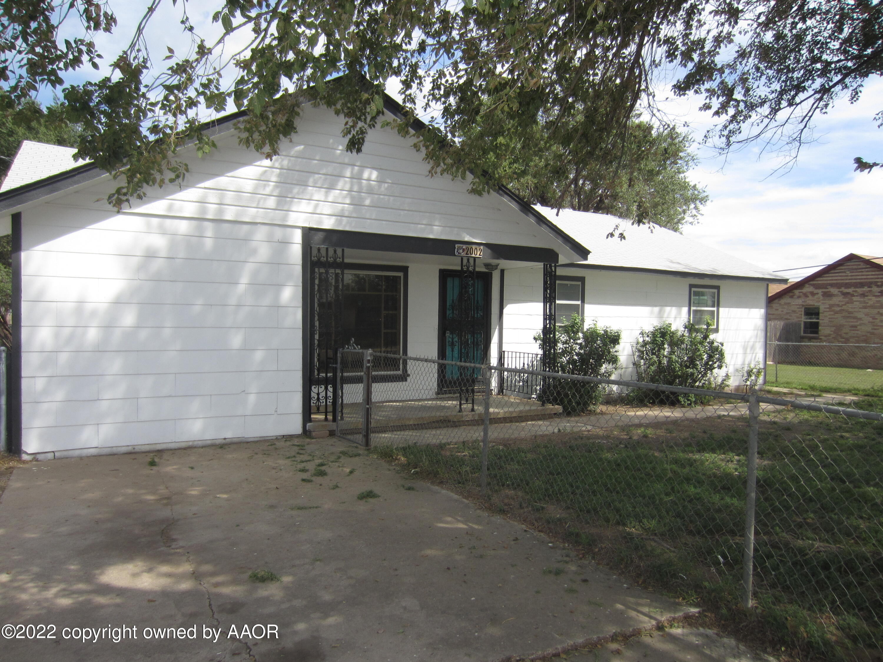 2002 North Mirror Street Amarillo, TX 79107 - Photo 2 of 13 a front view of a house with a yard