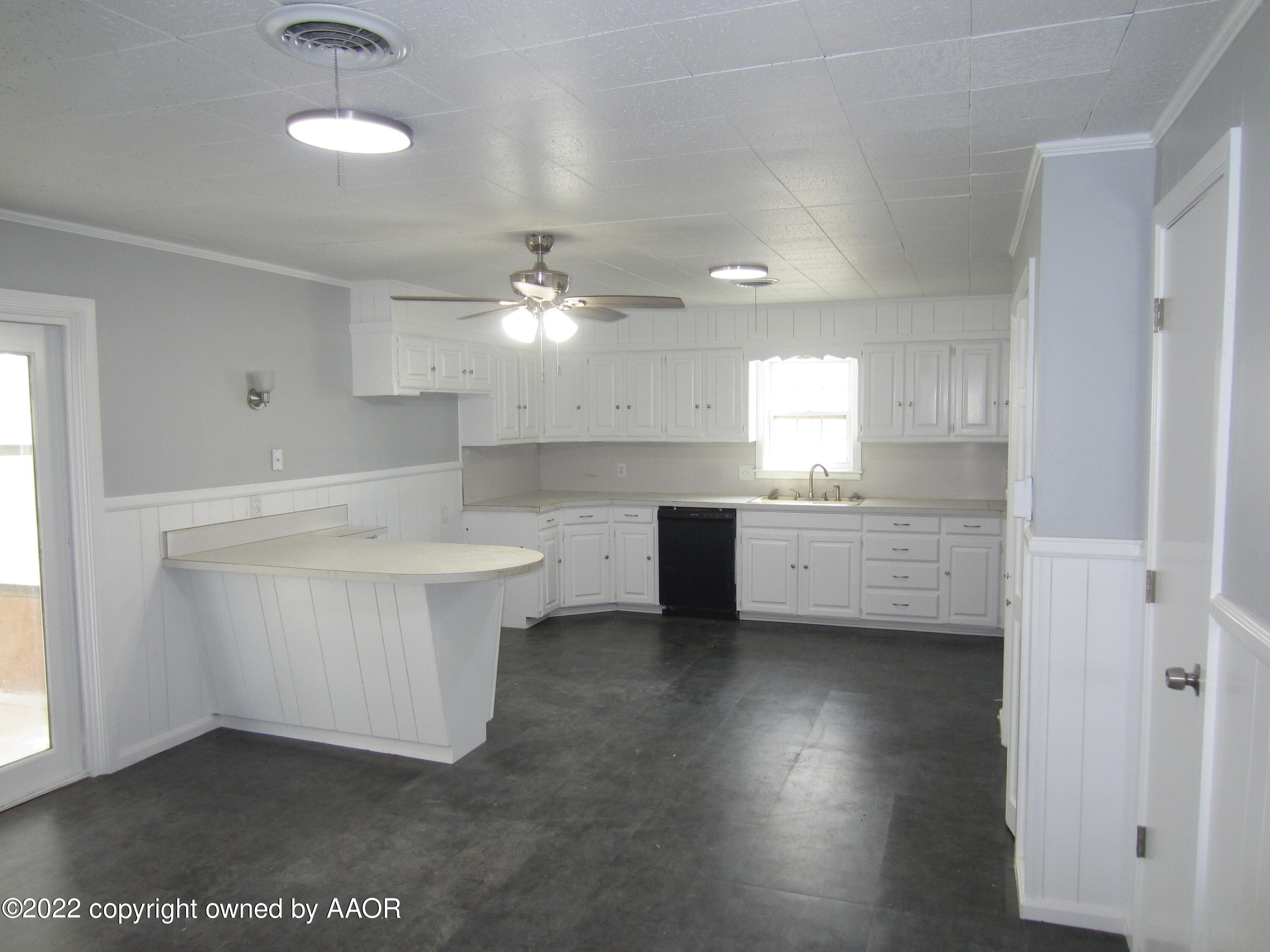 2002 North Mirror Street Amarillo, TX 79107 - Photo 3 of 13 a kitchen with kitchen island a sink stainless steel appliances and cabinets
