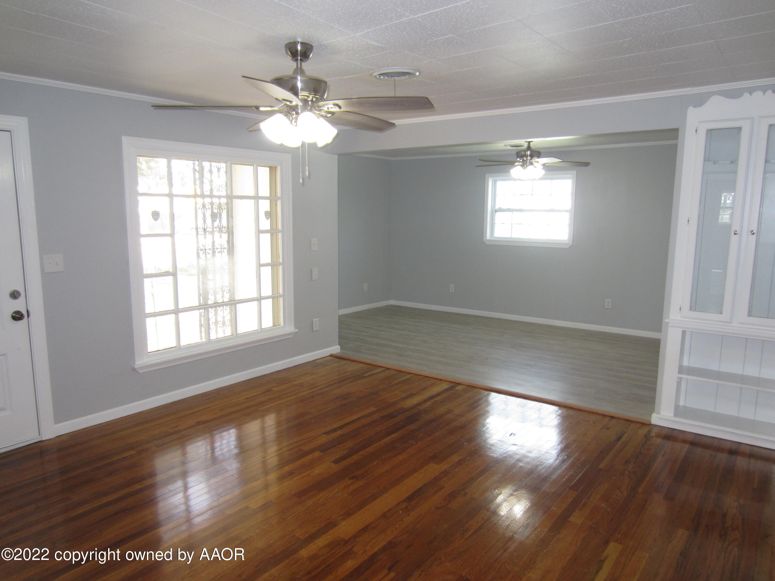 2002 North Mirror Street Amarillo, TX 79107 - Photo 5 of 13 a view of an empty room with wooden floor and a window