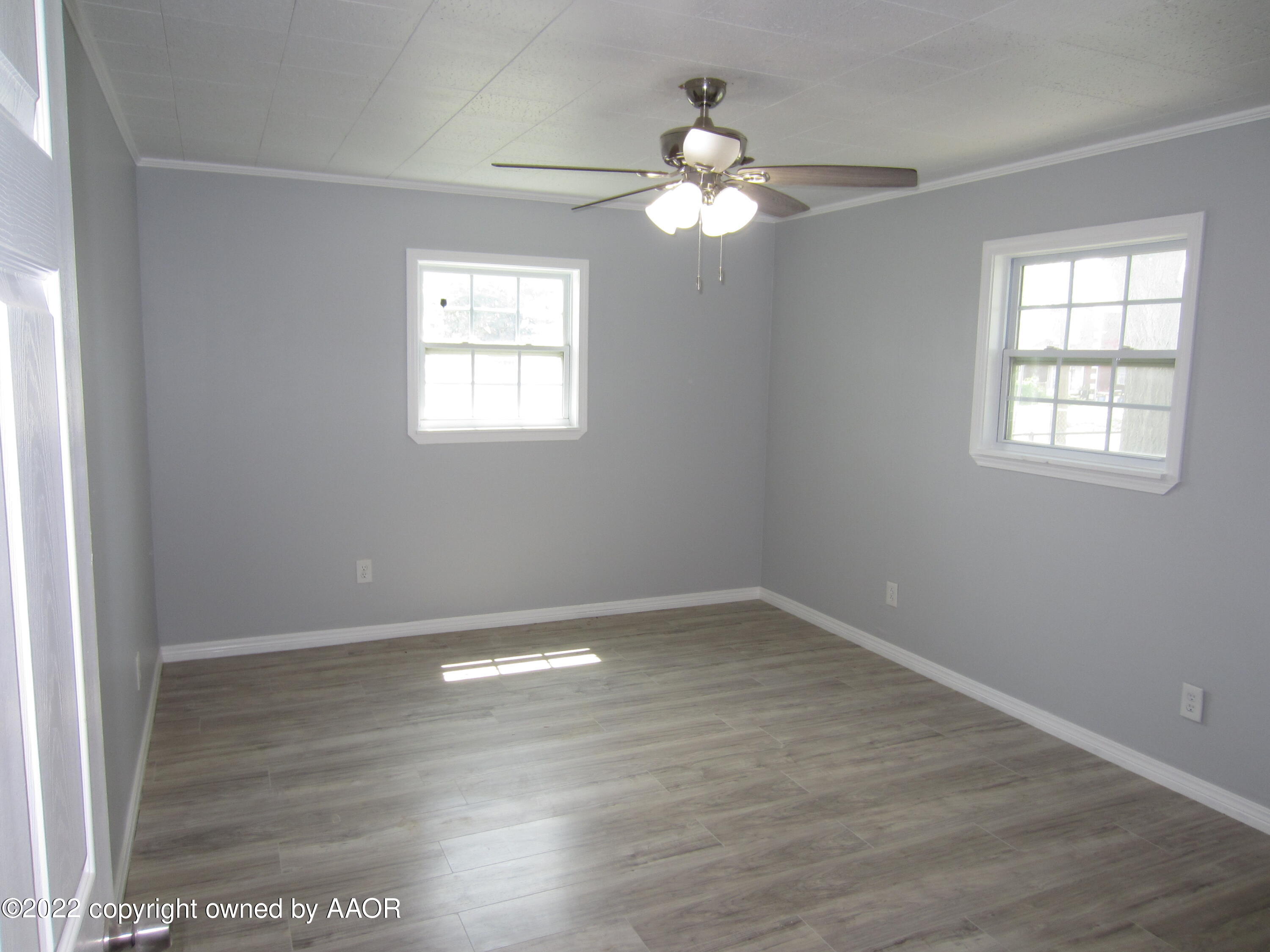 2002 North Mirror Street Amarillo, TX 79107 - Photo 7 of 13 an empty room with wooden floor and windows