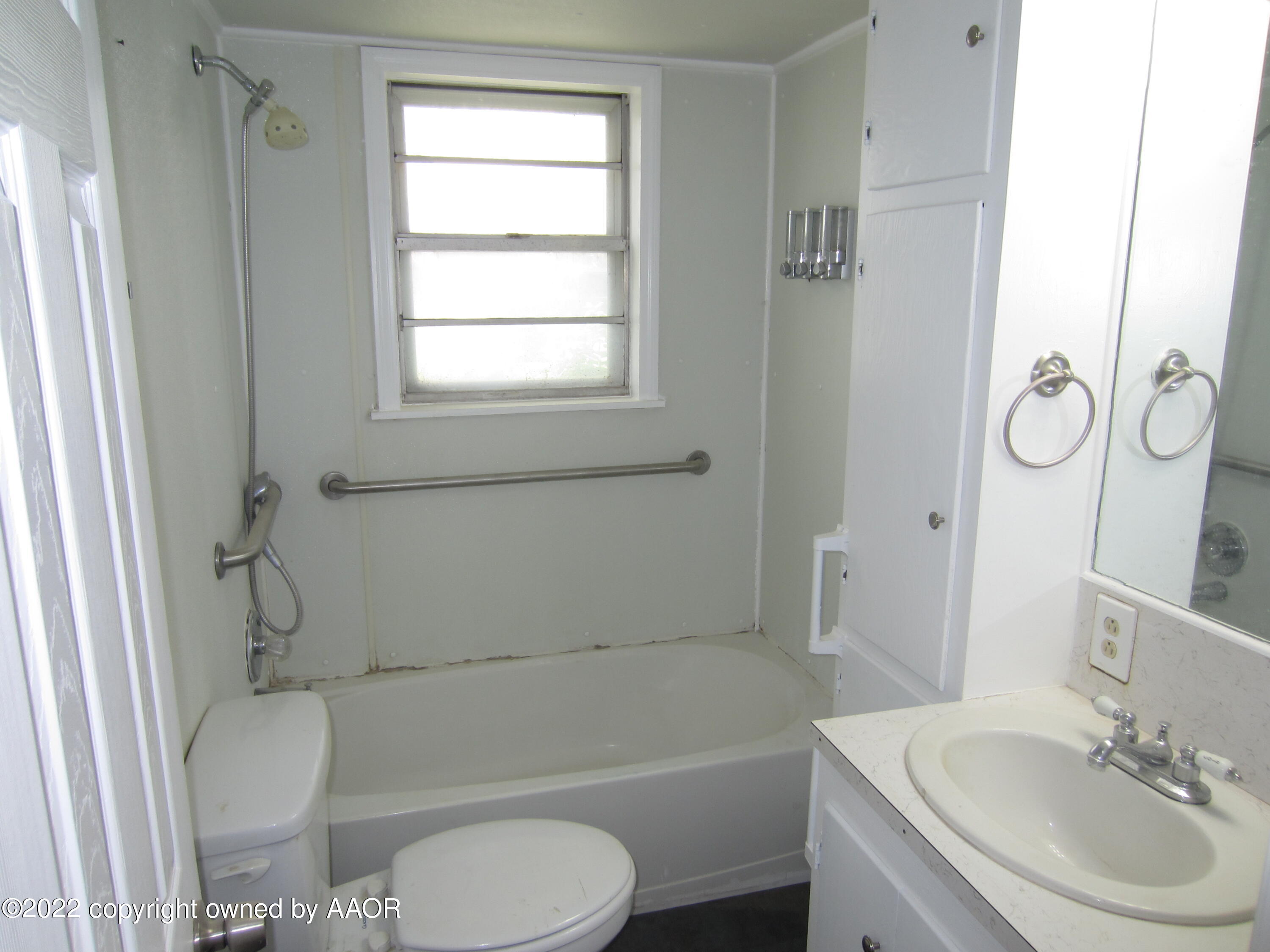 2002 North Mirror Street Amarillo, TX 79107 - Photo 8 of 13 a bathroom with a sink toilet a mirror and shower