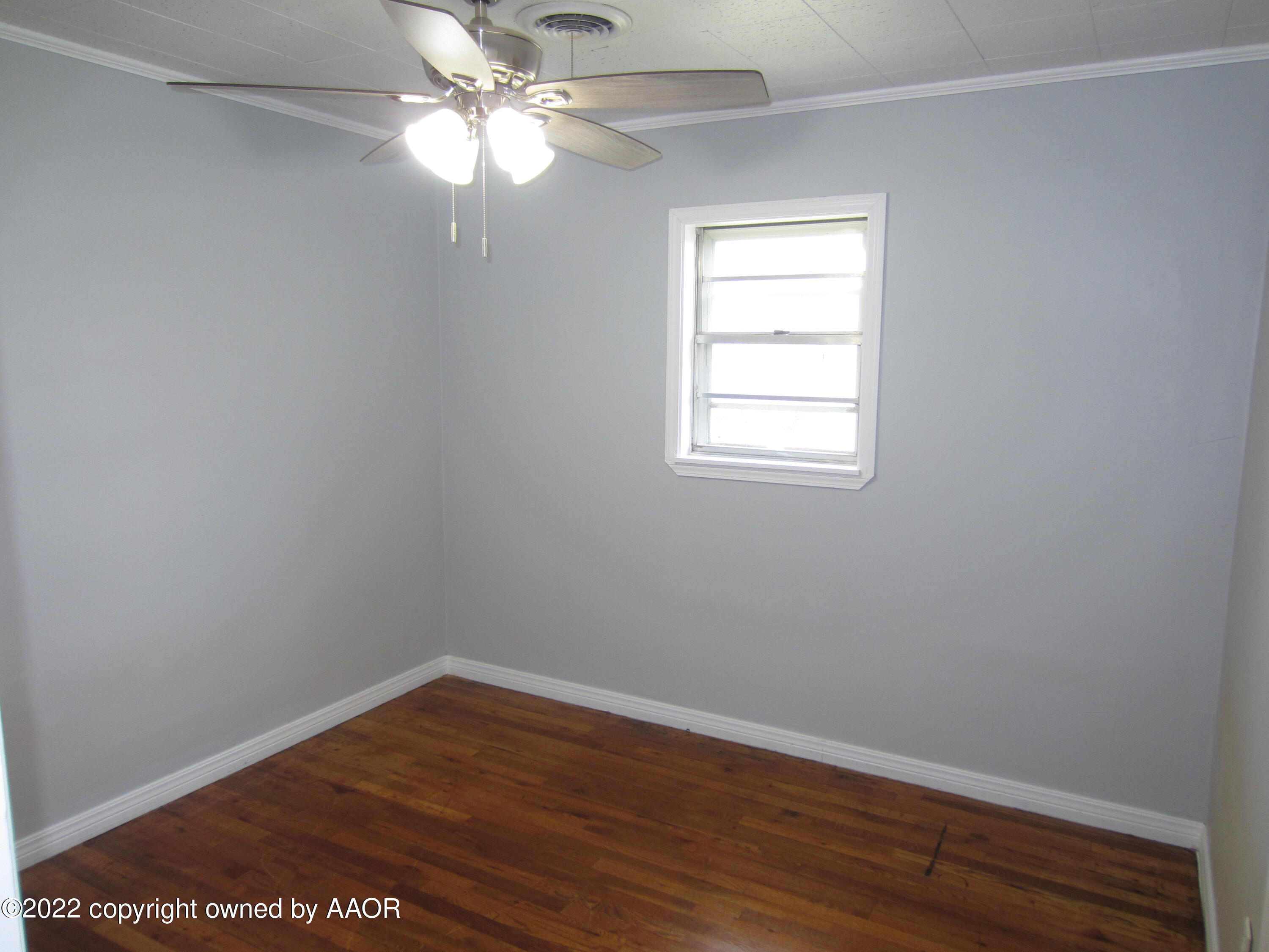 2002 North Mirror Street Amarillo, TX 79107 - Photo 10 of 13 an empty room with wooden floor closet and windows